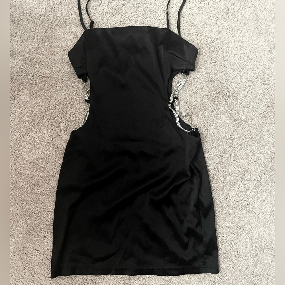 Satin black dress with open sides.
